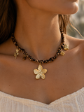 Collier fleur dorée sur ruban léopard
